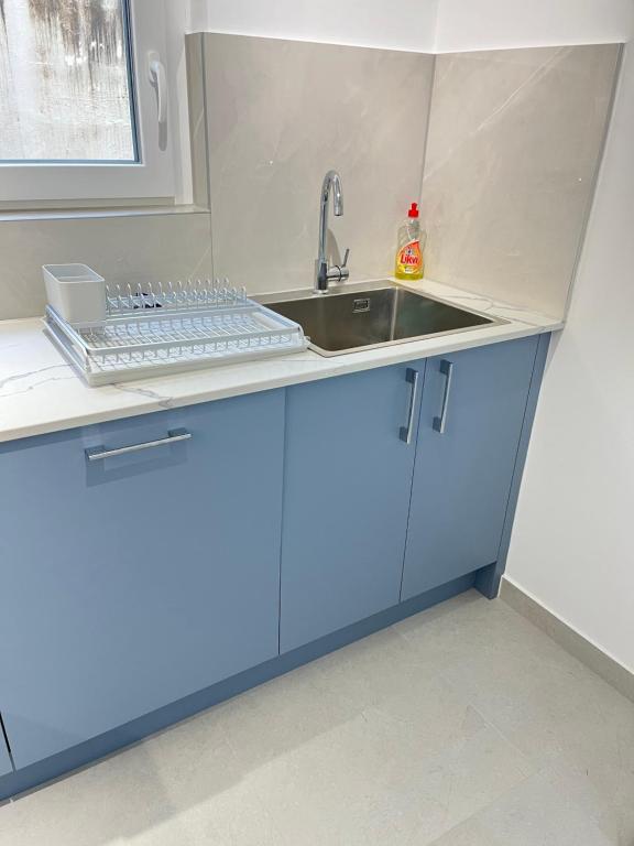 a kitchen with a sink and a keyboard on a counter at Apartment Darna in Neum