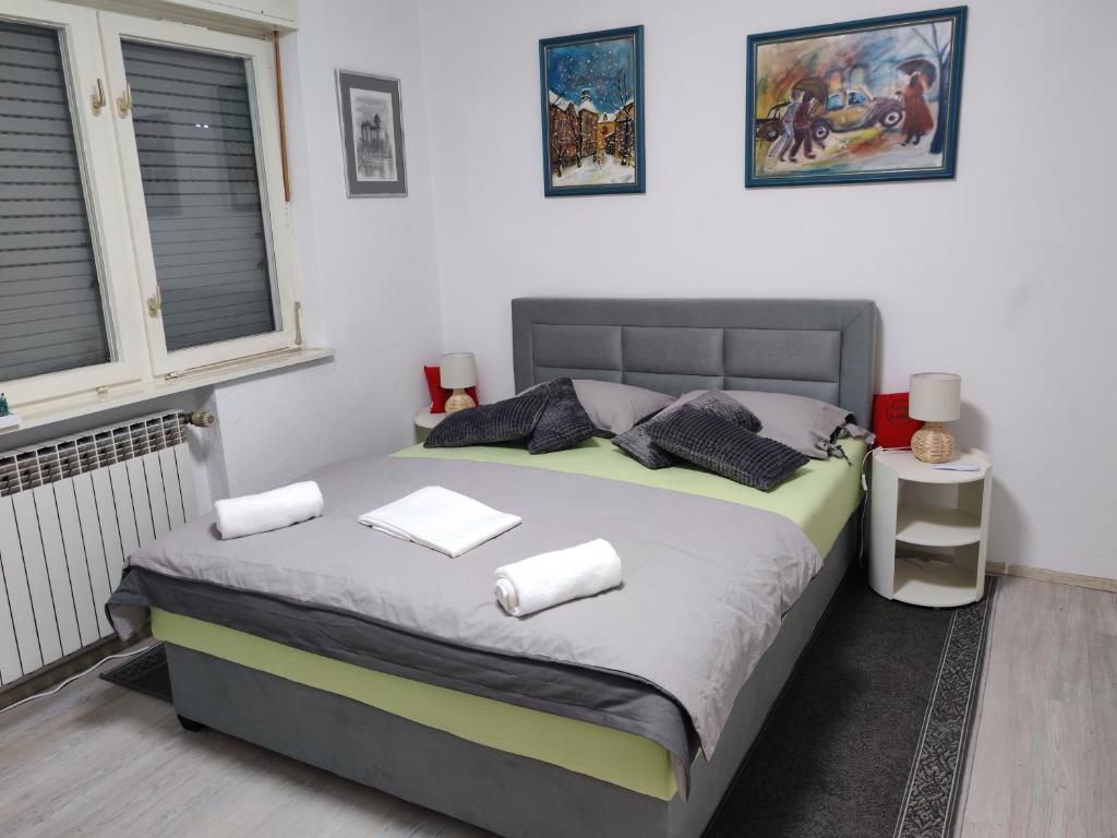 a bedroom with a bed with two pillows on it at Apartman Ivana in Karlovac