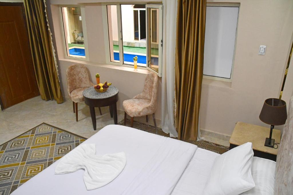 Postel nebo postele na pokoji v ubytování Nun Pyramids Hotel