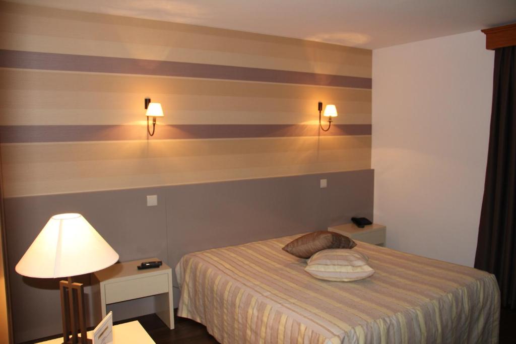 Postel nebo postele na pokoji v ubytování Troia Hotel