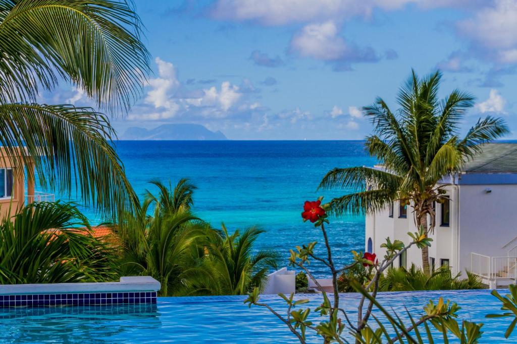 a swimming pool with a view of the ocean at La Vista Resort in Simpson Bay