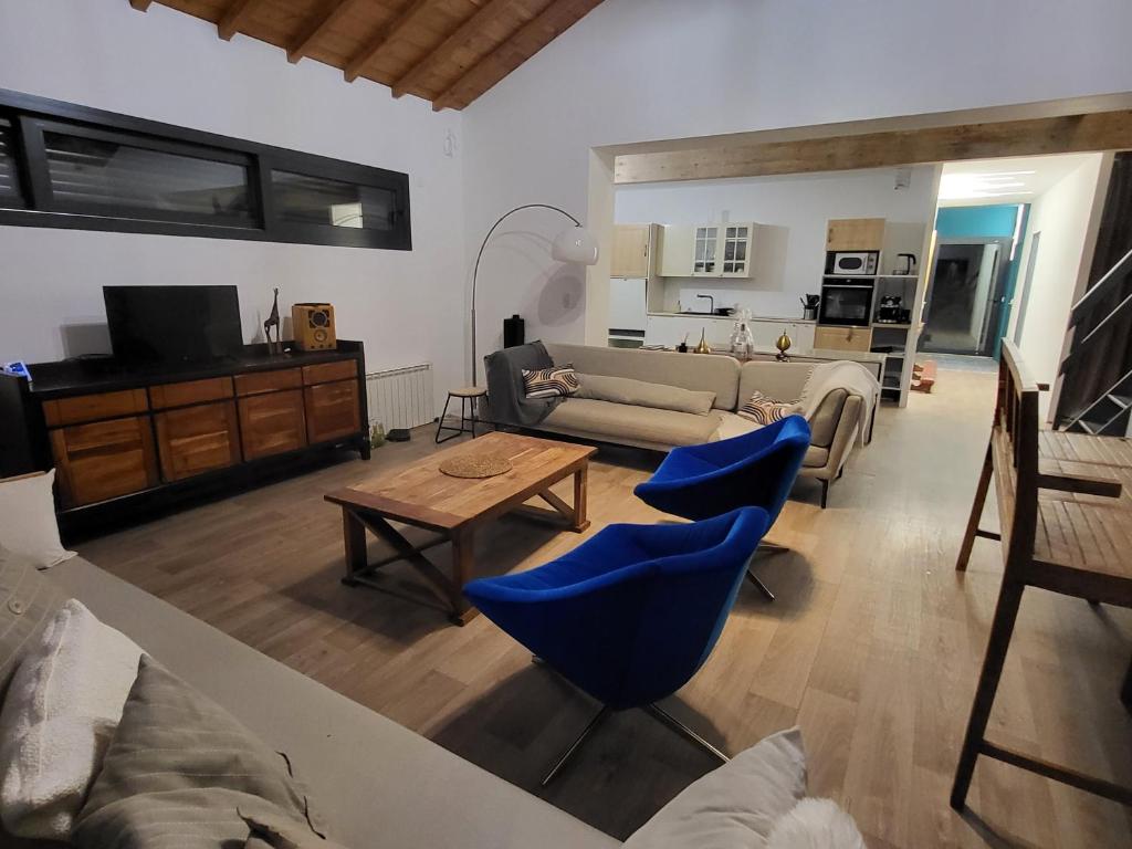 a living room with a couch and blue chairs at Maison familiale in Le Teich