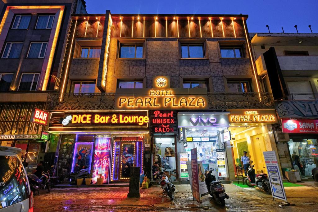 a building on a street at night with neon signs at Hotel Pearl Plaza - Paharganj - New Delhi in New Delhi