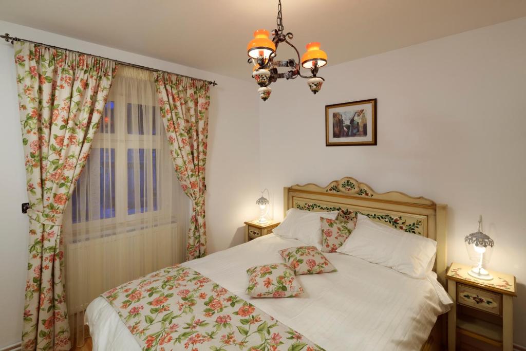a bedroom with a bed and a chandelier at Apartment Wine House in Sibiu