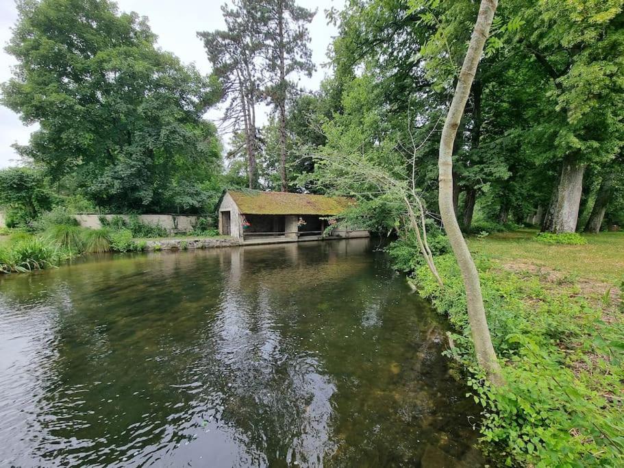 une maison assise sur le bord d'une rivière dans l'établissement Maison de campagne, à Gironville-sur-Essonnes