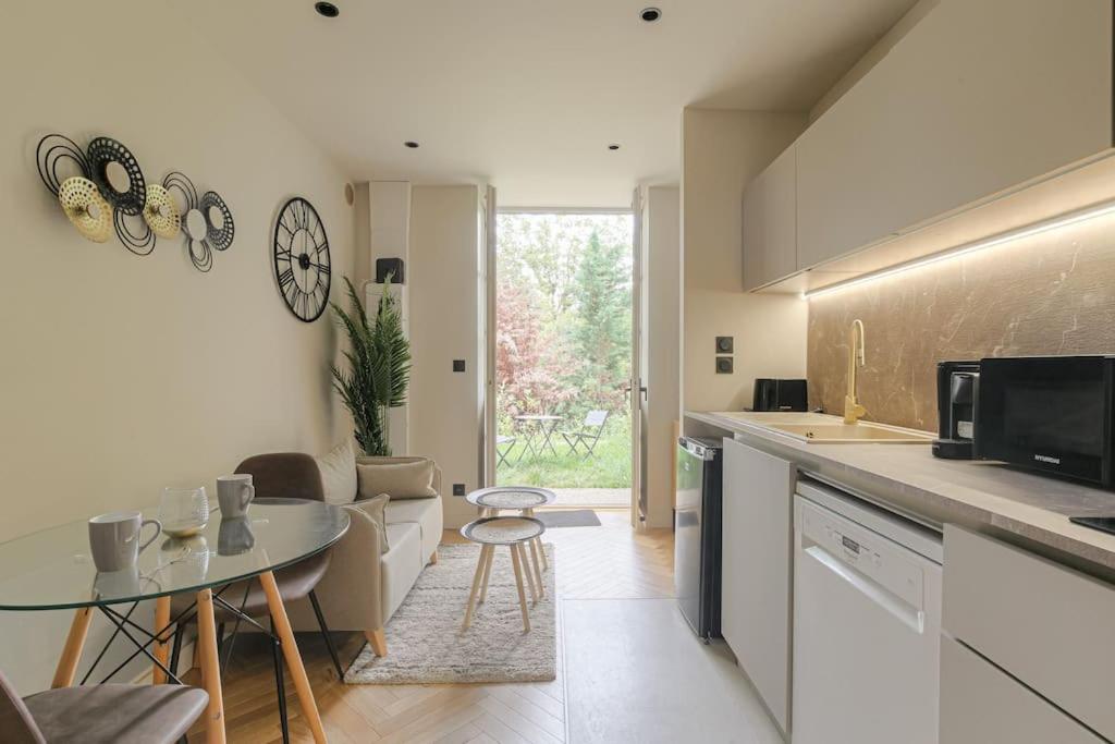 - une cuisine avec un canapé et une table dans une chambre dans l'établissement Joli duplex avec jardin, 2 personnes, Écully, à Écully