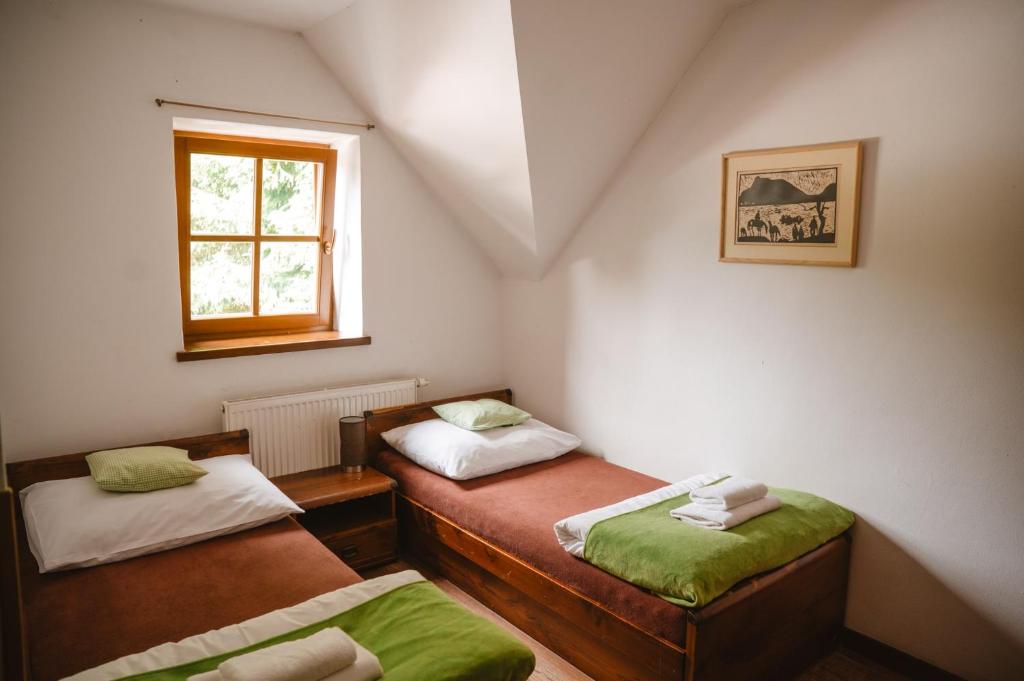 A bed or beds in a room at Majláthova Chata Popradské Pleso