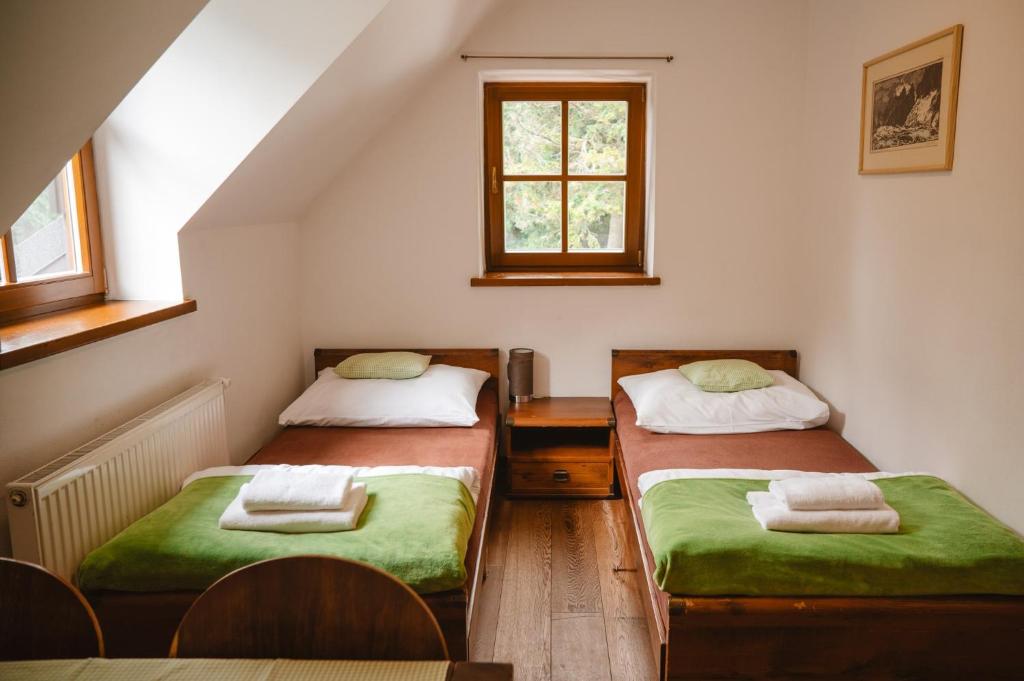 A bed or beds in a room at Majláthova Chata Popradské Pleso