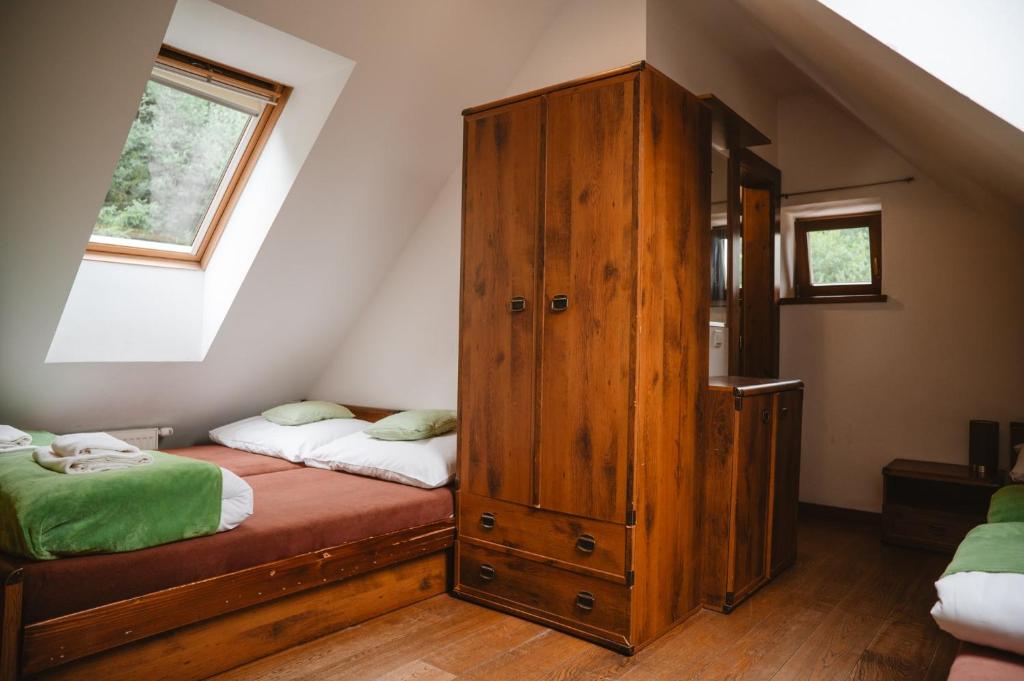 A bed or beds in a room at Majláthova Chata Popradské Pleso
