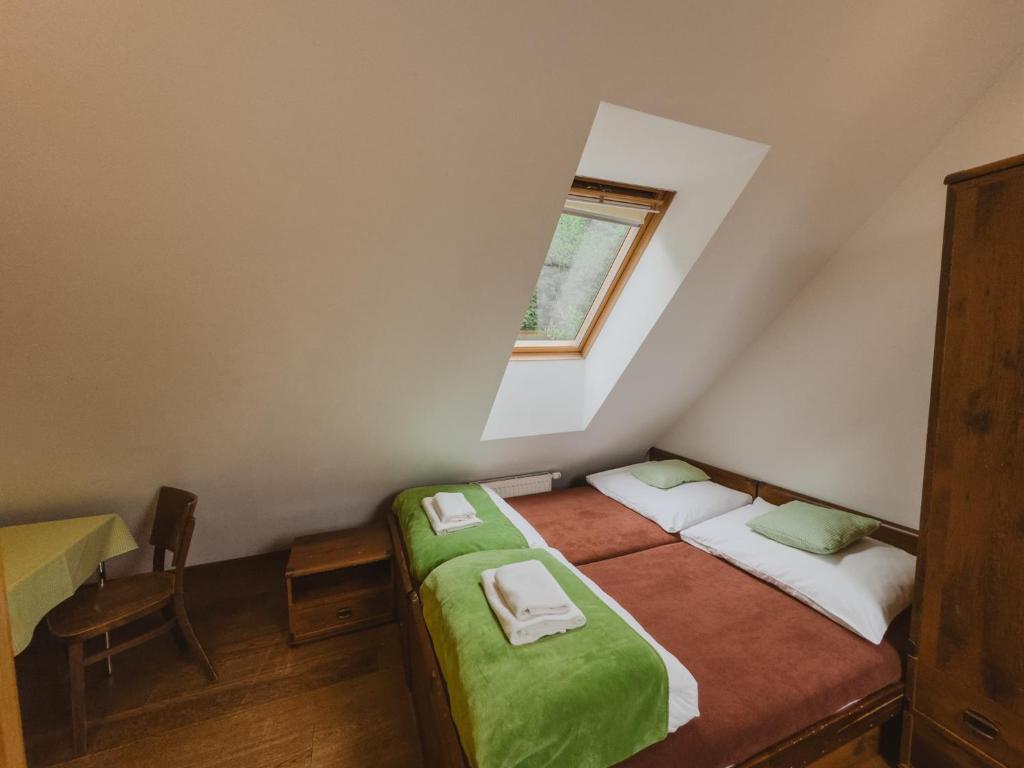 A bed or beds in a room at Majláthova Chata Popradské Pleso