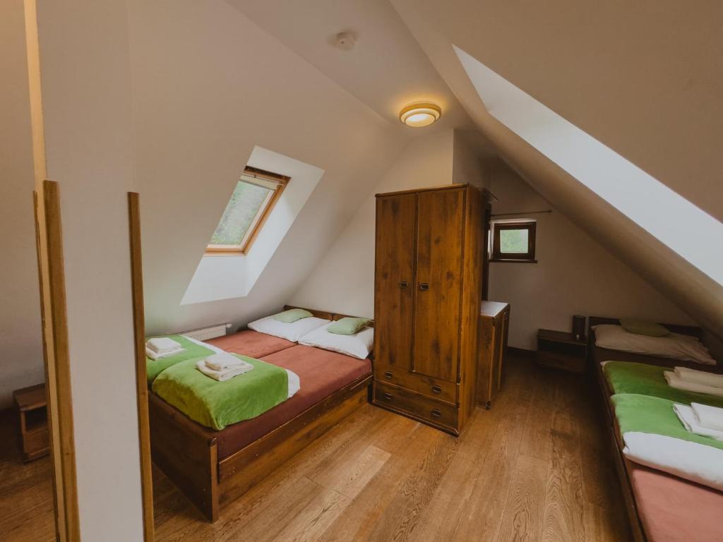 A bed or beds in a room at Majláthova Chata Popradské Pleso