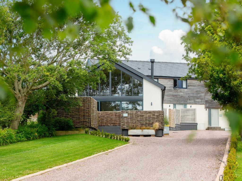 a brick house with a glass facade at The Barn in Amlwch