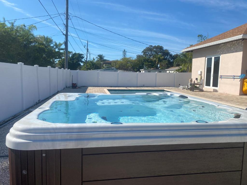 a hot tub in the backyard of a house at Paradise Pool House in Dania in Dania Beach
