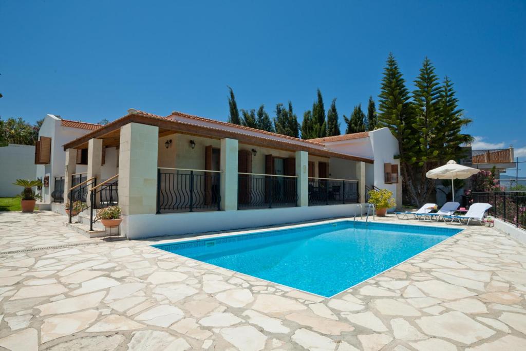 a swimming pool in front of a house at Amalia Villa in Polis Chrysochous