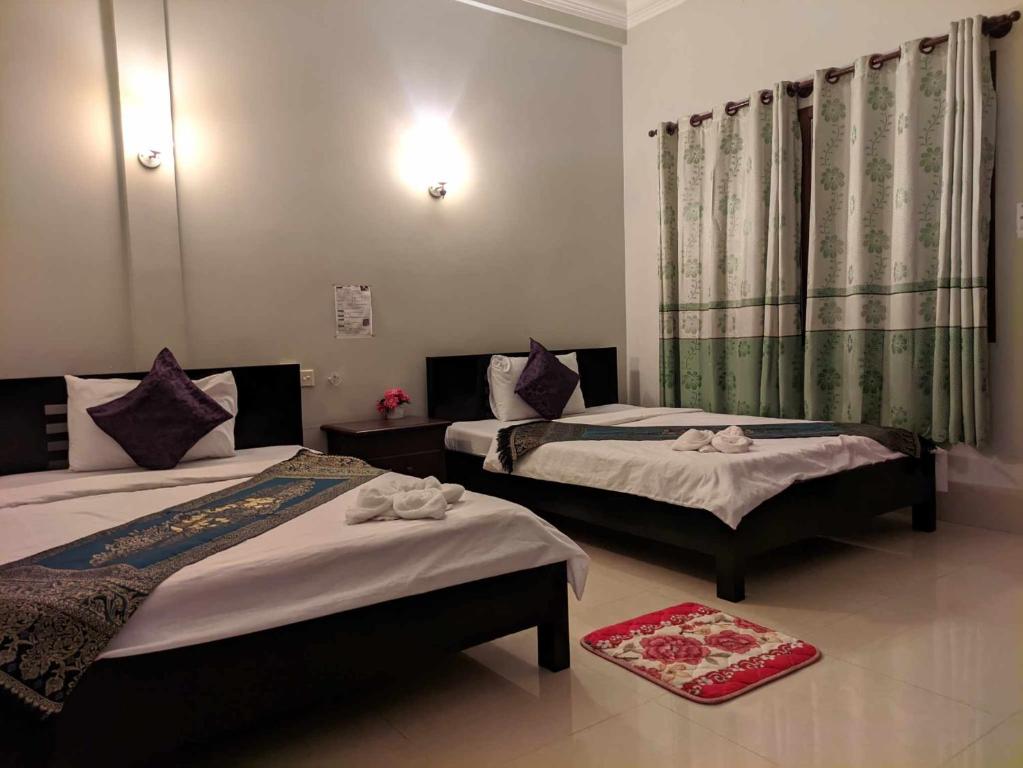 Postel nebo postele na pokoji v ubytování IKI IKI Guesthouse