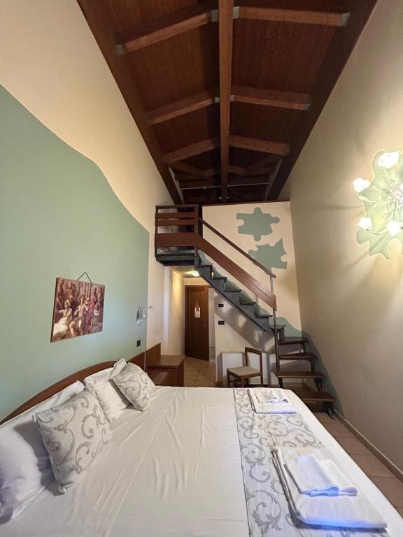 Postel nebo postele na pokoji v ubytování Hotel Duca Della Corgna