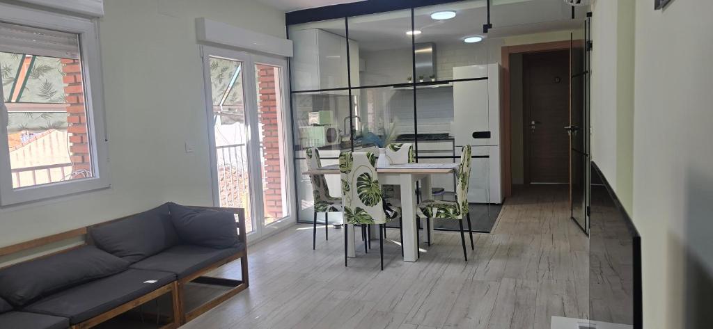 a living room with a couch and a table and chairs at BREZO Apartamentos turisticos in Guadalajara