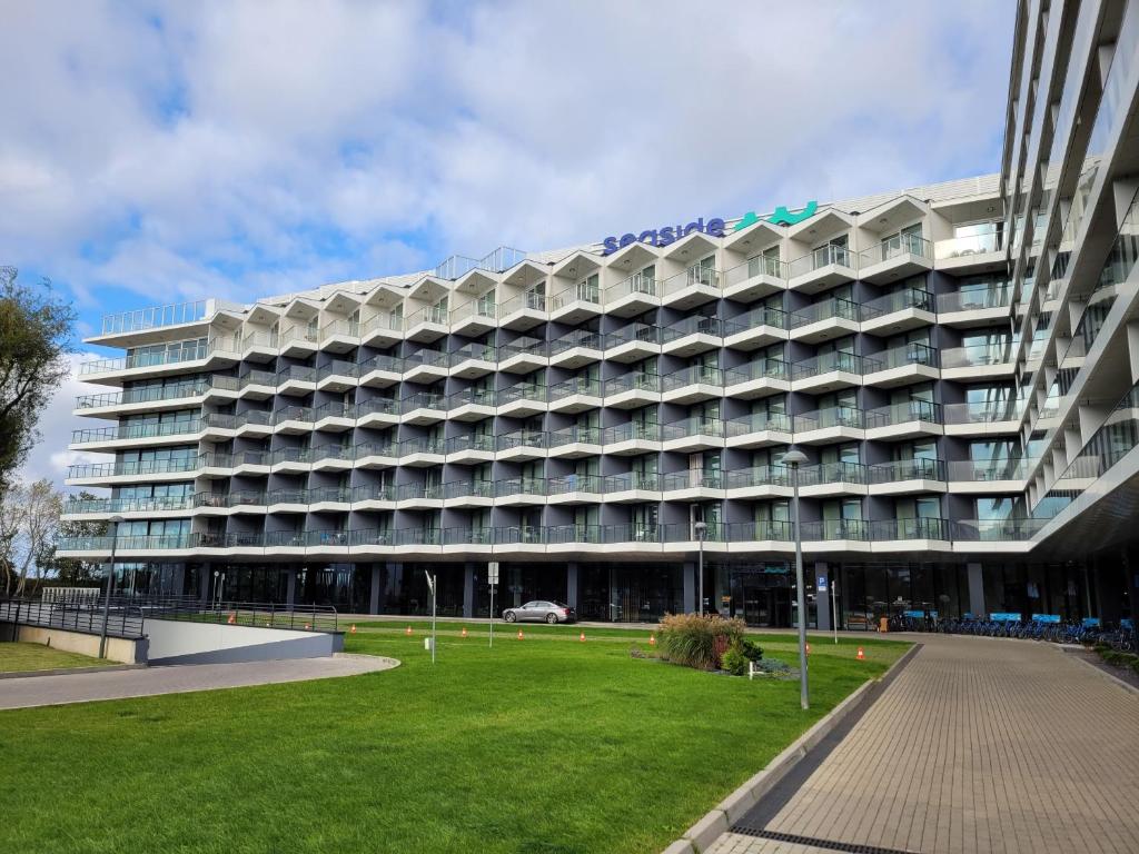 duży budynek z trawnikiem przed nim w obiekcie Seaside Park Resort w Kołobrzegu