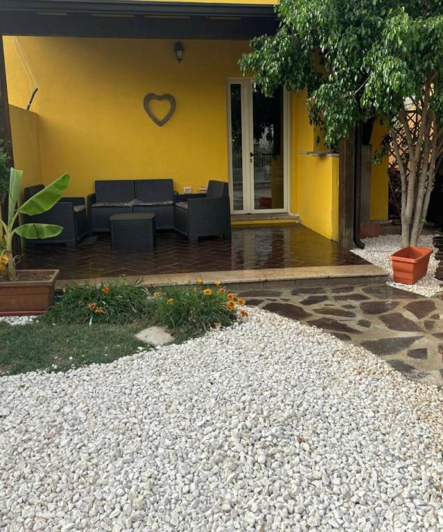 a yellow building with a heart on the wall at Dream House in San Giovanni Suergiu