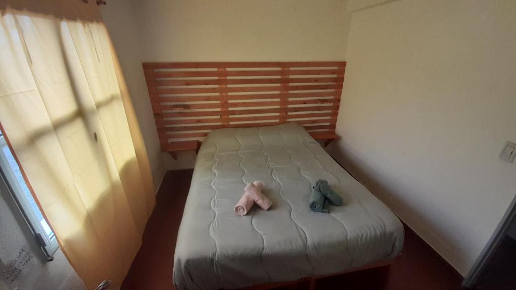 Postel nebo postele na pokoji v ubytování Hostel House 64Bigüa