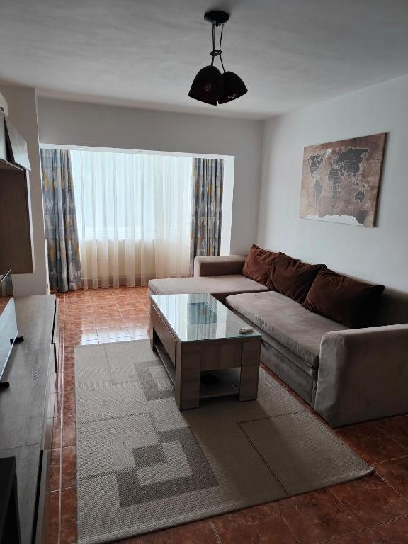a living room with a couch and a coffee table at Mari's By The Sea in Mangalia