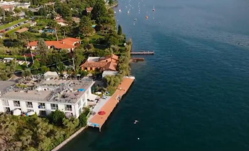 an aerial view of a house on the shore of a lake at Direttamente Al Lago Apartments in Marone