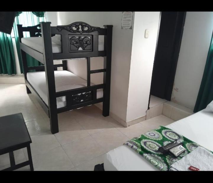 Postel nebo postele na pokoji v ubytování Hotel Villa Rocio Curumani