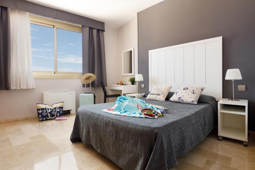 Postel nebo postele na pokoji v ubytování Hotel Alguer