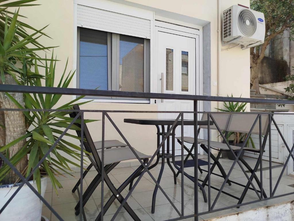 a balcony with a table and chairs on it at Billy´s Seaside Apartment in Iraklitsa