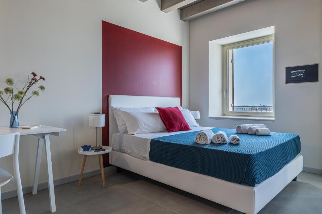 a bedroom with a bed with a red headboard at Verona Skyline Apartments - Appartamento 9D in Verona