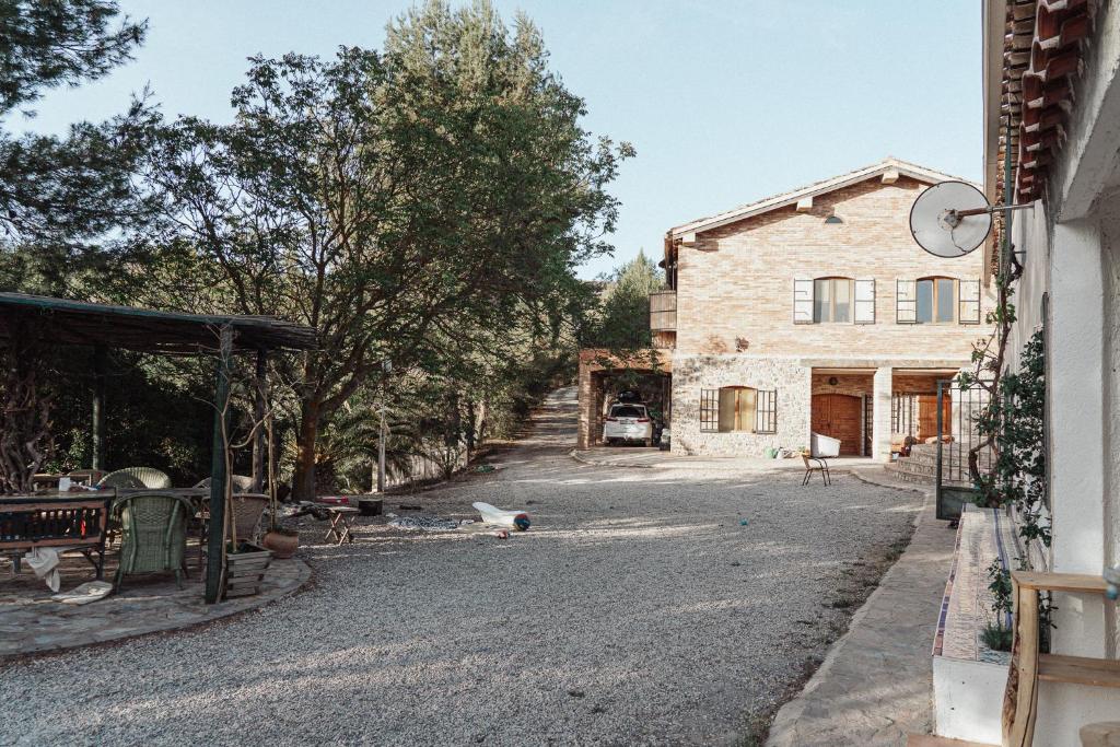 a stone house with a barn and a driveway at Nature Home Maitreya in Lorca