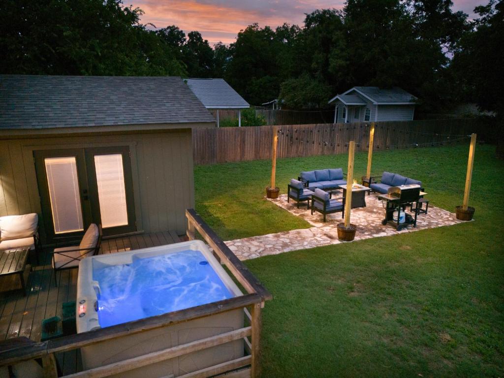 a backyard with a hot tub in a yard at The Olive Branch - Hot Tub & Walk to Main in Fredericksburg