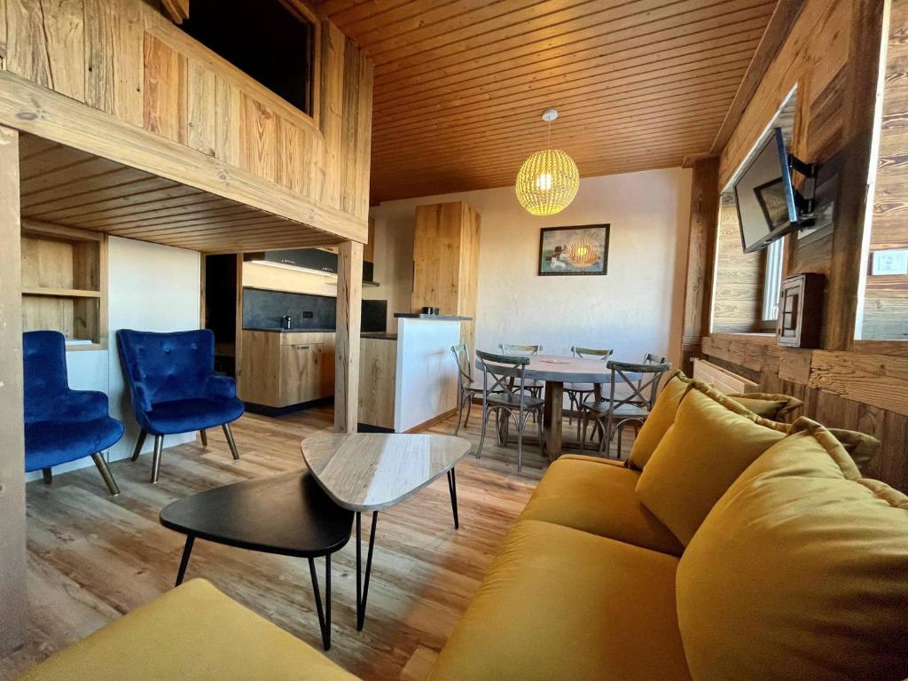 a living room with a couch and a table at T2 cabine Courchevel avec accès piste, parking et wifi - FR-1-514-22 in Courchevel