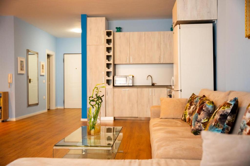 a living room with a couch and a table at Tirana Centre Lions Gate 3 in Tirana