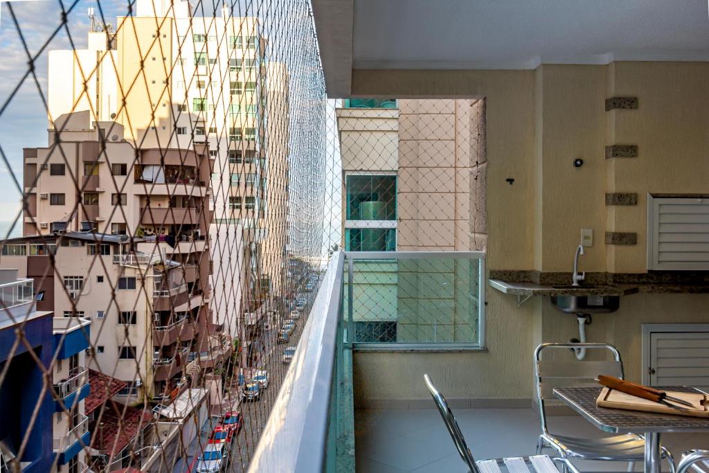 a balcony with a view of a city at Com garagem e banheira a 150m da praia N1188 in Itapema