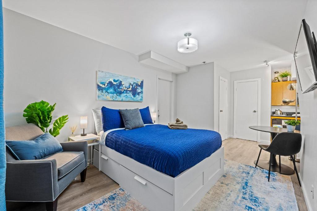 a bedroom with a bed and a desk and a chair at Highly Recommended Studio Near Times Square in New York