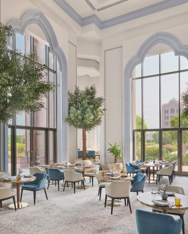 a rendering of a restaurant with tables and chairs and windows at Emirates Palace Mandarin Oriental, Abu Dhabi in Abu Dhabi