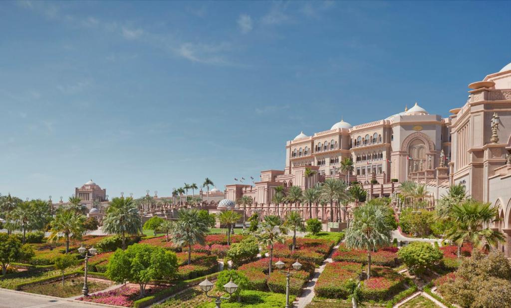 a large building with a garden in front of it at Emirates Palace Mandarin Oriental, Abu Dhabi in Abu Dhabi