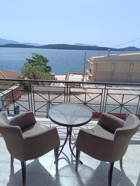 a patio with a table and two chairs and a table and chairs at sailors apartments Perigiali in Nydri