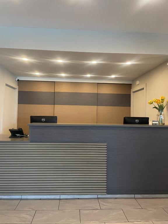 a lobby with a reception counter with flowers on it at Plantation Inn in Houma