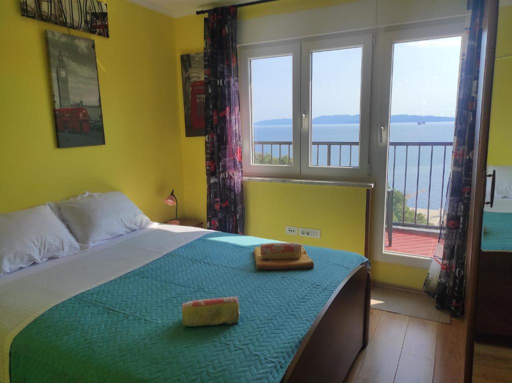 a bedroom with a bed with two towels on it at Apartman Yuriel - Sea View in Rijeka