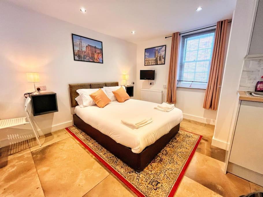 a bedroom with a large bed and a television at The City Pad in Gloucester
