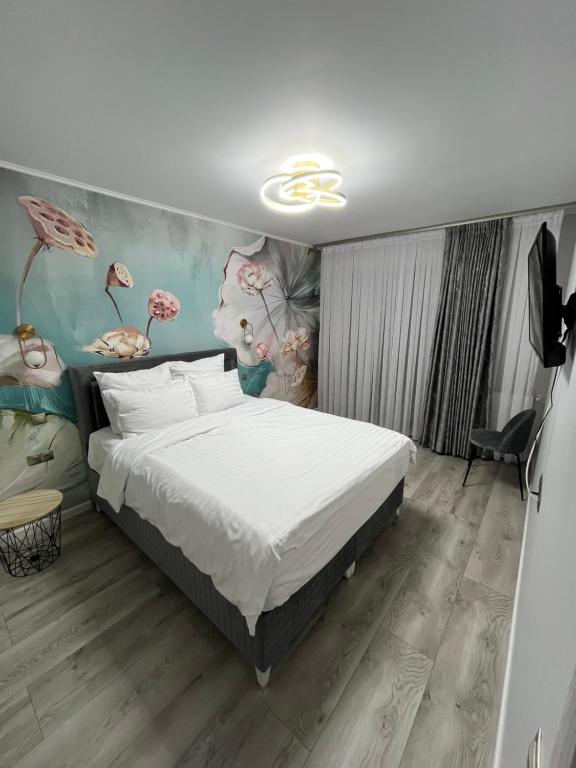 a bedroom with a bed and a painting on the wall at Glam Studios in Sibiu