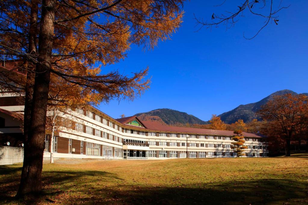 a building with a tree in front of it at Nikko Astraea Hotel in Nikko