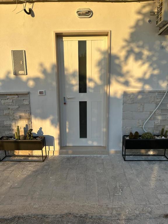 a front door of a house with a table and a window at Summertime's House in Peschici