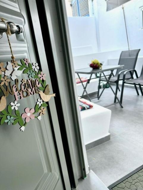 a door with a flower wreath on it at Lilianna Tinos in Tinos