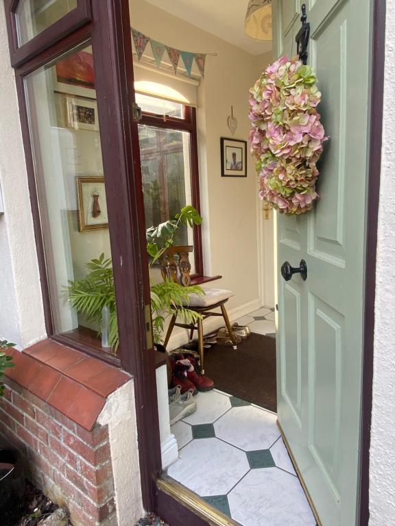 a door leading into aoyer with a flower wreath at 2 Bed Retreat by Lake, Hotel and Golf Course in Tulfarris