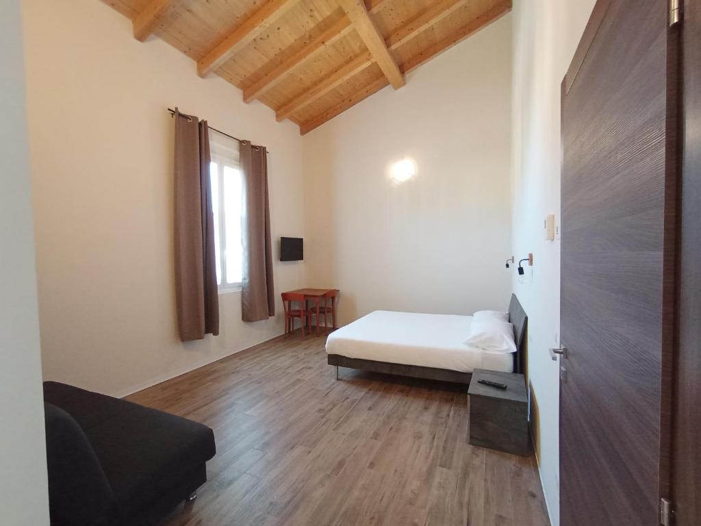 Postel nebo postele na pokoji v ubytování Casa nel borgo di Capraia