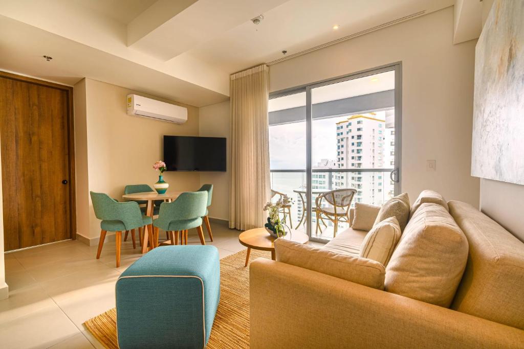 a living room with a couch and a table at Exclusive Luxury Jr Suite 1BRD By ENCOR in Gaira