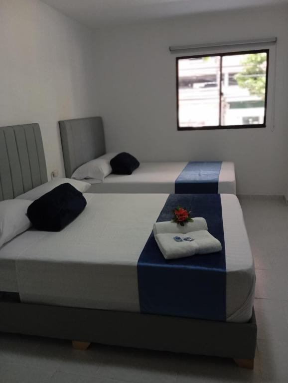 Postel nebo postele na pokoji v ubytování Hotel San Juan 70 Express Medellin